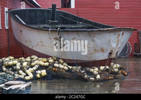 Hoonah, Alaska: Ein rostetes Fischerboot und verschiedene Fischernetze sind im Besucherzentrum von Icy Strait Point in Hoonah, Alaska, ausgestellt. Stockfoto