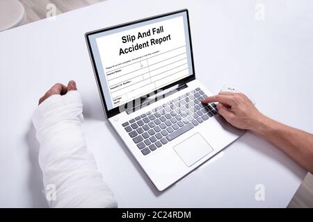 Nahaufnahme von einer Person Hand Befüllen Krankenversicherung Antragsformular über Weiß Schreibtisch Stockfoto