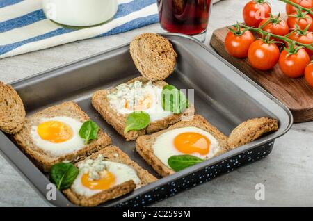 Gebackene Bullauge Eiern auf Vollkorn Toast mit Spinat und Blauschimmelkäse an der Spitze Stockfoto