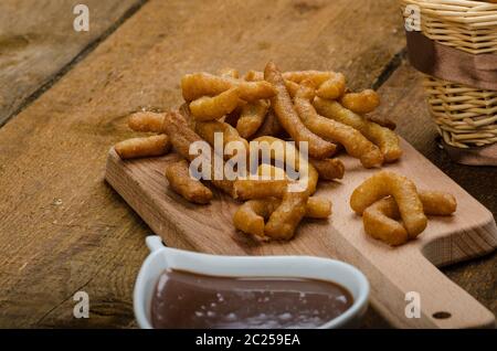 Churros mit Schokolade Dip - Dahmsdorfer Essen, tief gebraten, sehr lecker, aber schwere Streetfood. Stockfoto