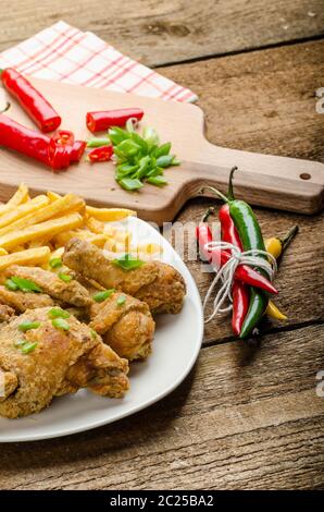 Fried Chicken, Chili Pommes Frites und Dip und Frühlingszwiebeln auf Essen Stockfoto