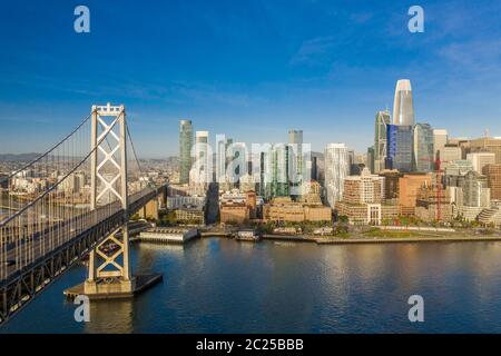 Luftaufnahme von San Francisco, Kalifornien, Skyline bei Sonnenaufgang. Viel Platz für Kopien in blauem Himmel. Bay Bridge im Vordergrund auf der linken Seite des Rahmens. Stockfoto