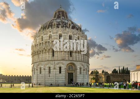 Das historische, runde Baptisterium neben dem Turm und dem Dom auf dem Feld der Wunder, in der toskanischen Stadt Pisa Italien bei Sonnenuntergang. Stockfoto