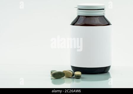 Vitamine, Ergänzungen und Mineralien Dual Layer tabletten Pillen und Medizin braunen Glasflasche mit leeren Label auf weißem Hintergrund mit Kopie sp isoliert Stockfoto