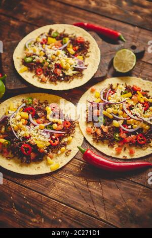 Gesunde Maistortillas mit gegrilltem Rindfleisch, frischen Paprika, Käse, Tomaten Stockfoto