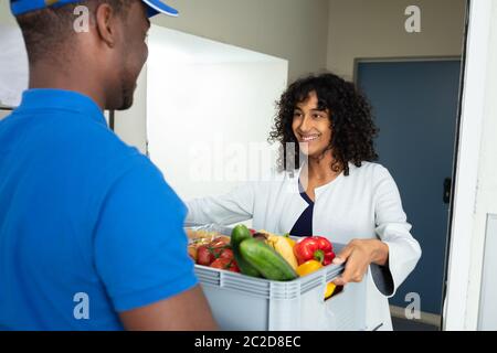 Lächelnde Frau, die ein Lieferservice für zu Hause Stockfoto
