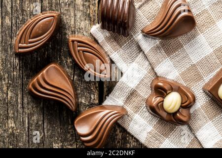 Verschiedene Pralinen auf alten Holztisch. Ansicht von oben. Stockfoto