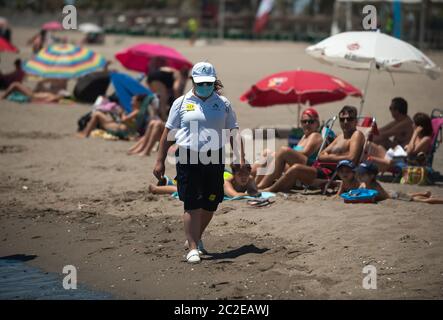 Malaga, Spanien. Juni 2020. Eine Strandhilfe mit Gesichtsmaske geht an einem sonnigen Tag am Strand von Misericordia entlang, während die Einschränkungen durch den Ausbruch von COVID-19 gelockert werden.die meisten Städte in Spanien befinden sich in Phase drei, in der Menschen in andere Provinzen derselben autonomen Gemeinschaft ziehen und gehen. Die spanische Regierung sagt, dass der Ausnahmezustand am 21. Juni nach drei Monaten Sperrung enden wird und dann eine "neue Normalität" beginnen wird, nach Gesundheits- und Sicherheitsmaßnahmen, bis ein Impfstoff vorliegt. Kredit: SOPA Images Limited/Alamy Live Nachrichten Stockfoto