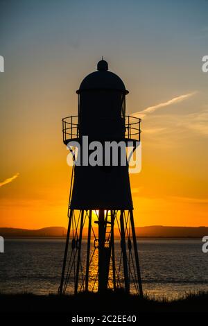 Black Nore Lighthouse in Portishead, Somerset, UK, bei Sonnenuntergang an einem Sommerabend mit der walisischen Küste in der Ferne. Stockfoto