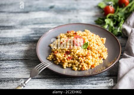 Ptitim oder Birdy, israelische Teigwaren Couscous mit Tomaten und Kräuter/ Stockfoto
