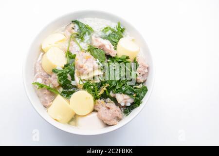 Gekochter Reis mit Schweinefleisch, Efeu-Kürbisblättern und weichem Tofu Stockfoto