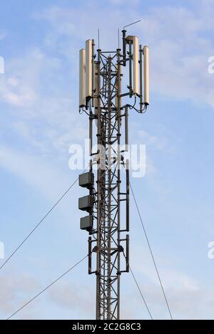 Mobilfunk Basisstation mit Panel Antennen gegen den blauen Himmel Stockfoto