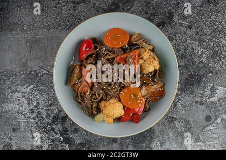 Soba-Nudeln mit Rindfleisch, Karotten, Zwiebeln und Paprika. Ansicht von oben Stockfoto