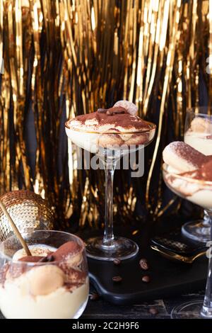 Festliche Tiramisu Dessert in Gläser mit goldenen Dekorationen für die Feiertage Stockfoto