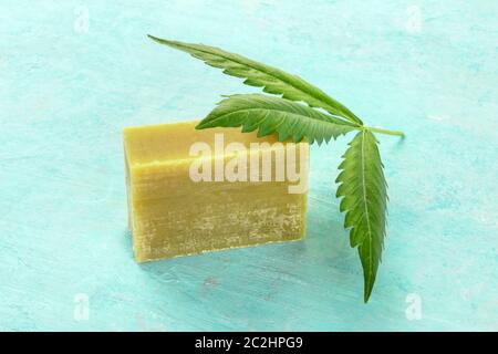 Ein Cannabis leaf mit hausgemachten Hanf Seife auf einem blauen Hintergrund Stockfoto