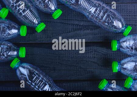 Frame Plastikflaschen Müll auf schwarzem Holz-, Umwelt Konzept recycelt Stockfoto