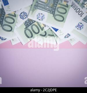 Euro cash auf einem Lila, Lila und Rosa Hintergrund. Euro Banknoten Geld. Euro Geld. Euro Rechnung. Für text Stockfoto