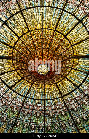 Glasfenster im Hauptkonzertsaal des Palastes der katalanischen Musik (Palau de la Música Catalana) in Barcelona, Katalonien, Spanien. Der Konzertsaal, der vom katalanischen Architekten Lluís Domènech i Montaner entworfen wurde, wurde zwischen 1902 und 1906 erbaut. Das riesige Glasfenster wurde vom katalanischen Künstler Antoni Rigalt i Blanch entworfen. Stockfoto