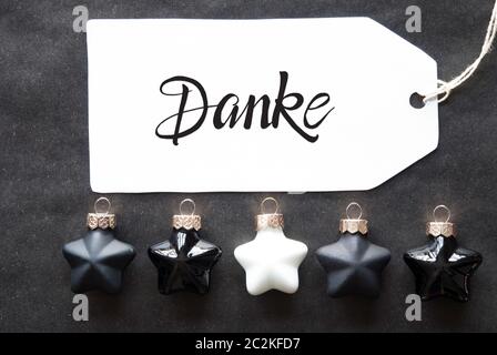 Etikett mit Deutschen Kalligraphie Danke, Danke. Black Christmas Ball Ornament. Stockfoto
