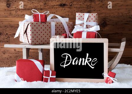 Tafel mit Deutschen Kalligraphie Frohe Weihnachten und ein Glueckliches 2020 bedeutet, frohe Weihnachten und einen guten Rutsch ins Jahr 2020. Schlitten mit Weihnachtsgeschenk und Pr Stockfoto