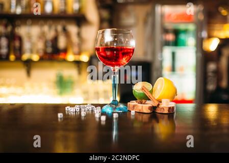 Getränke in Glas, Lime, Zitrone, Salz und Würfel auf hölzernen Theke Stockfoto