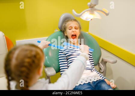 Kinder in Uniform spielen Zahnarzt Arzt, Spielzimmer. Kinder spielt Medizin Arbeiter in imaginären Krankenhaus, stomatologist Beruf lernen, kindliche dr Stockfoto