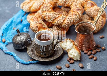 Türkischer schwarzer Kaffee in traditioneller Keramikschale mit Sesambagel, selektiver Konzentration. Stockfoto