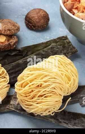 Udon Nudeln, close-up mit getrockneten Meer Gemüse Kelp, Shiitake-pilze, und Katsuobushi Thunfisch Flocken, Ramen Zutaten Stockfoto