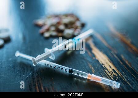 Süchtiger Kit, Betäubungsmittel Konzept, sucht Problem. Pillen sind auf den Tisch gelegt, die Spritze für Dosis Stockfoto