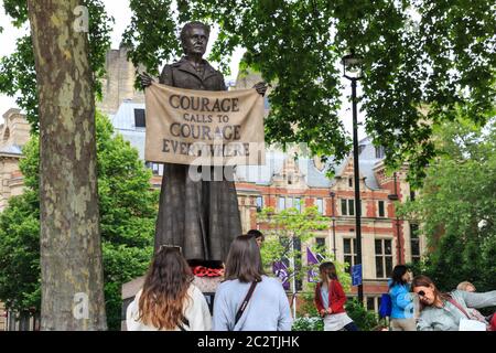 Die Menschen betrachten die Bronzestatue von Millicent Garrett Fawcett, Frauenrechtlerin und Frauenrechtlerin, Parliament Square, London Stockfoto