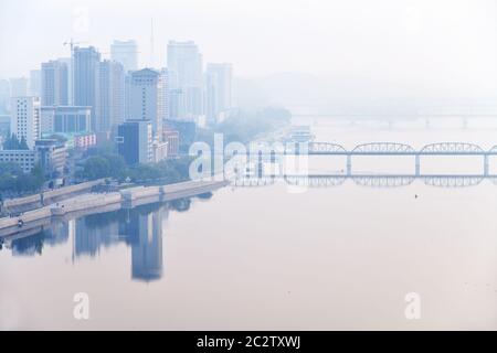 Skyline und Taedong River im Morgennebel. Blick von der Yanggakdo Insel Stockfoto