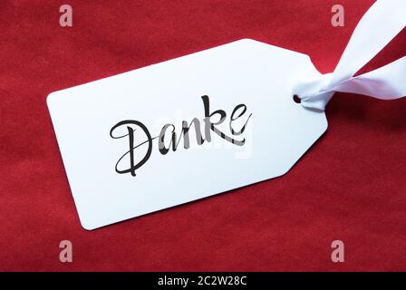 Etikett mit Deutschen Kalligraphie Danke, Danke. Red strukturierten Hintergrund Stockfoto