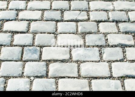 Die Straße gepflastert mit Pflastersteinen für Ihren Hintergrund Stockfoto