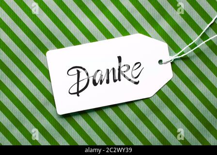 Etikett mit Deutschen Kalligraphie Danke, Danke. Grüne Verpackung Papier als Hintergrund Stockfoto