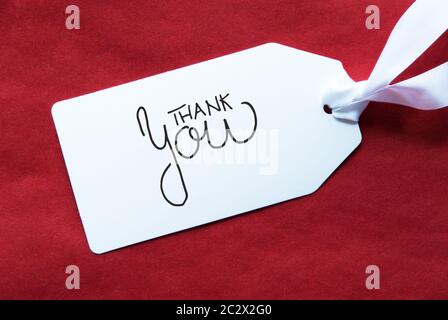 Etikett mit englischen Kalligraphie Danke. Red strukturierten Hintergrund Stockfoto
