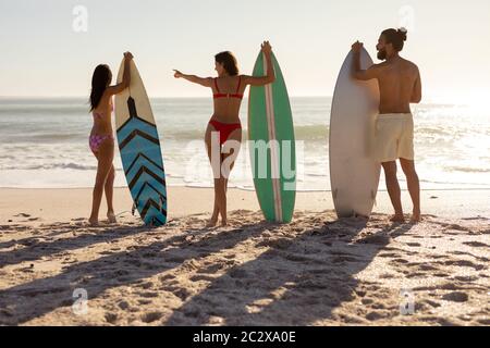Multiethnische Gruppe von Männern und Frauen, Surfen am Strand Stockfoto