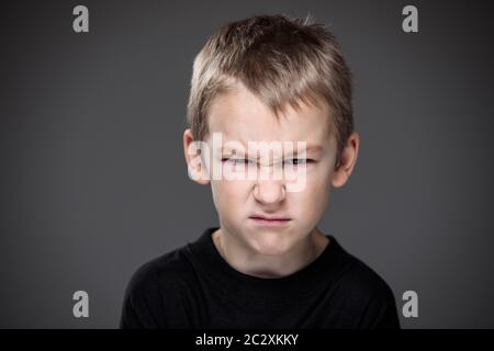 Lasten der Aggression in einem kleinen Jungen - Ausbildung Konzept hinting Verhaltensstörungen bei Kindern (flacher DOF) - kleiner Junge mit Händen ballte ich Stockfoto