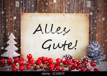 Papier mit deutschem Text alles Gute, die besten Wünsche. Weihnachtsdekoration und Holz- Hintergrund mit Schnee Stockfoto