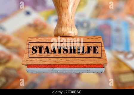 Symbolbild Konjunkturpaket, Stempel mit Aufschrift STAATSTHILFE, Deutschland Stockfoto