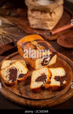 Marmorne Laibkuchen auf dunklem Holzbrett Stockfoto