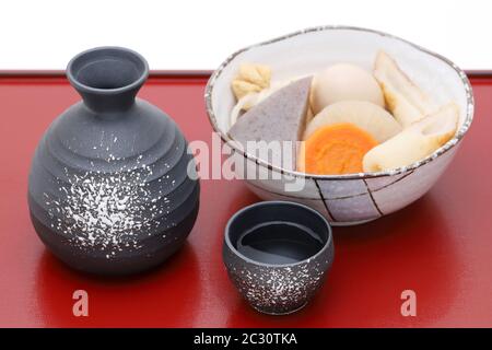 Traditionelle japanische Sake Becher und Flaschen mit Oden auf Fach Stockfoto