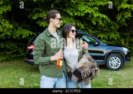 Junge glückliche Paar Spaß in der Nähe des Autos haben Wochenende außerhalb der Stadt. Urlaub und Roadtrip Konzept Stockfoto