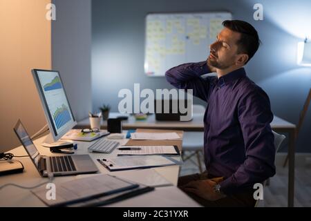 Foto von Unternehmer leiden unter Nackenschmerzen Stockfoto