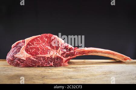 Trocken gealterte Wagyu Tomahawk Steak auf einem hölzernen Schneidebrett Stockfoto