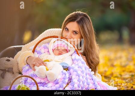 Die Mutter legte sich das Baby in den Korb und blickte in den Rahmen Stockfoto