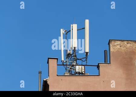 Signalgeber für Mobilfunknetz auf einem Gebäudedach Stockfoto