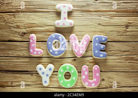 "Ich liebe Dich" In Cookies auf einer hölzernen Hintergrund geschrieben Stockfoto