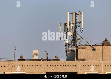 Signalgeber für Mobilfunknetz auf einem Gebäudedach Stockfoto