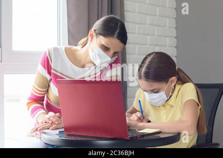 Mutter und Tochter verstehen gemeinsam Online-Dienste für Fernunterricht Stockfoto