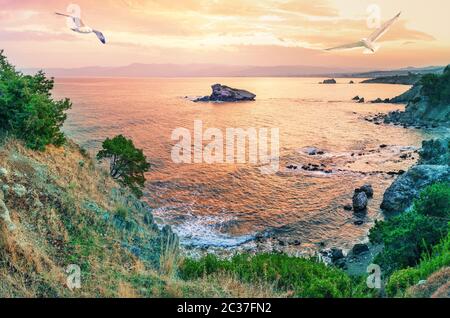 Kap Akamas Bucht mit Möwen am Himmel bei Sonnenuntergang. Aussicht von der berühmten Aphrodite Trail. Mittelmeer. Ein beliebtes Touristenziel. Zypern Stockfoto